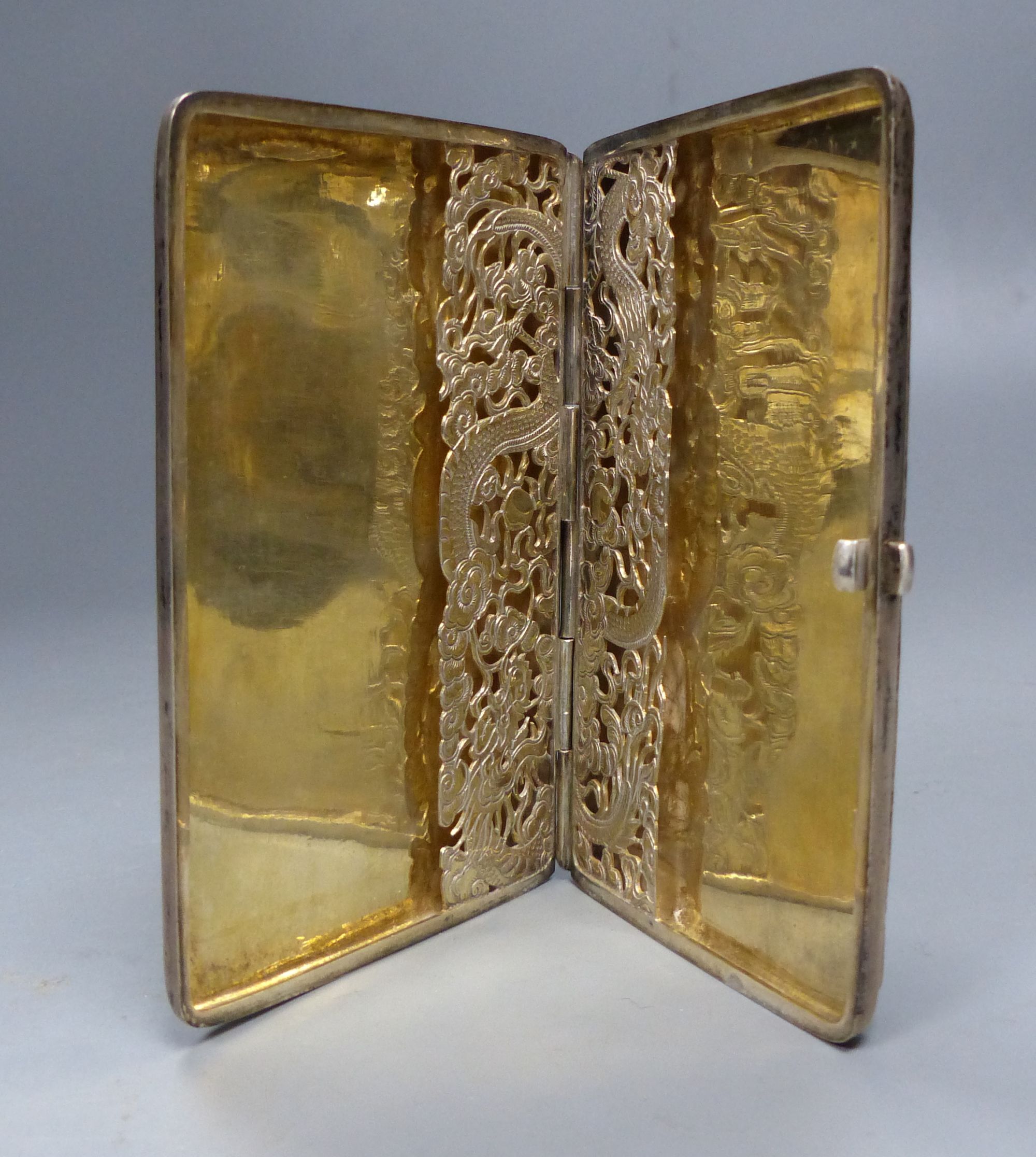 A late 19th century Chinese Export white metal card case, decorate with figures at various pursuits in landscape scene,